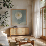Single White Daisy by Danhui Nai. Shown in a natural wood frame in a cozy modern living room. Available as an archival giclee rolled canvas, fine art paper, or poster print. SKU 5183a.