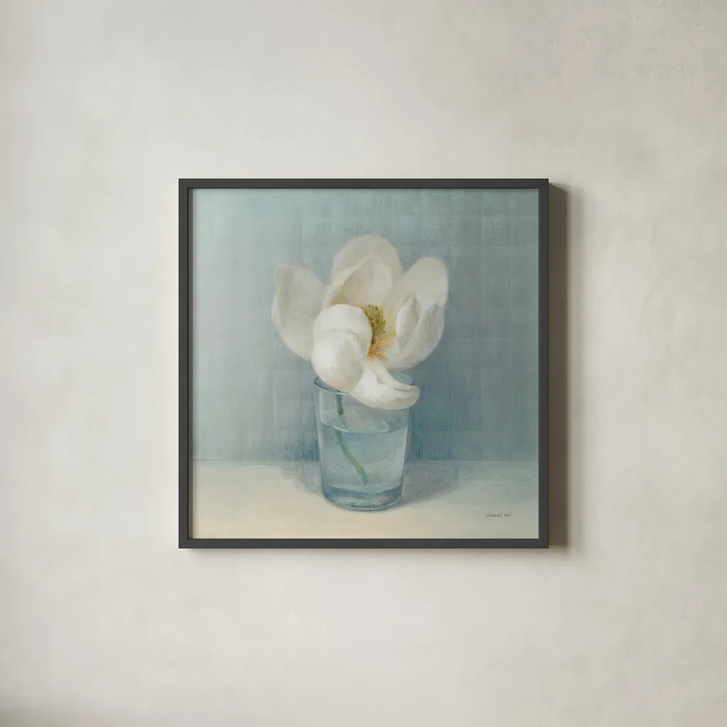 Single White Magnolia by Danhui Nai. Shown in a sleek black glass frame for a contemporary gallery look. Available as an archival giclee rolled canvas, fine art paper, or poster print. SKU 5185a.