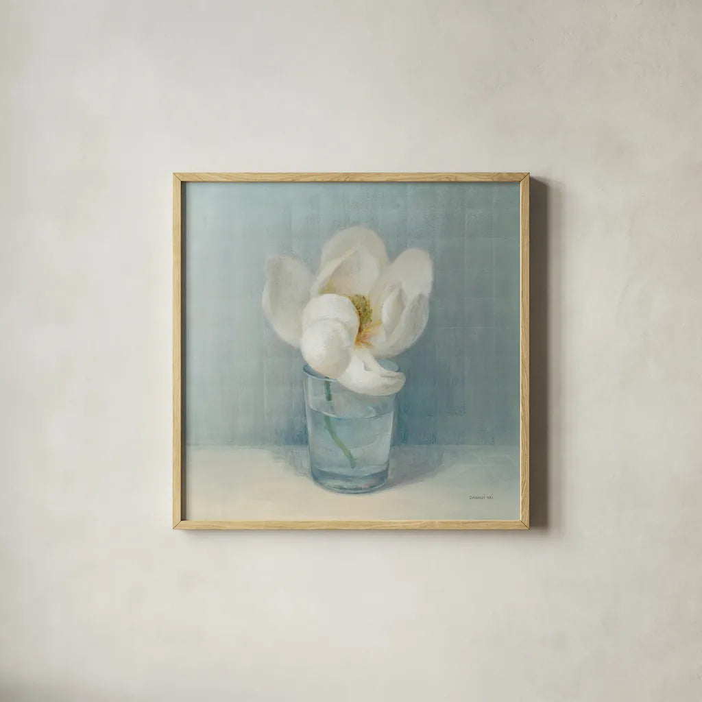 Single White Magnolia by Danhui Nai. Shown in a natural wood glass frame for a timeless modern aesthetic. Available as an archival giclee rolled canvas, fine art paper, or poster print. SKU 5185a.