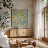 Spring Dream Paisley II by Danhui Nai. Shown in a natural wood frame in a cozy modern living room. Available as an archival giclee rolled canvas, fine art paper, or poster print. SKU 24933a.