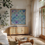 Touching Circles II by Danhui Nai. Shown in a natural wood frame in a cozy modern living room. Available as an archival giclee rolled canvas, fine art paper, or poster print. SKU 44153a.