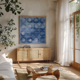 Touching Circles III Navy by Danhui Nai. Shown in a natural wood frame in a cozy modern living room. Available as an archival giclee rolled canvas, fine art paper, or poster print. SKU 67900a.