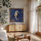 Treasures from the Sea Indigo I by Danhui Nai. Shown in a natural wood frame in a cozy modern living room. Available as an archival giclee rolled canvas, fine art paper, or poster print. SKU 20048a.