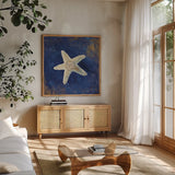 Treasures from the Sea Indigo IV by Danhui Nai. Shown in a natural wood frame in a cozy modern living room. Available as an archival giclee rolled canvas, fine art paper, or poster print. SKU 20051a.