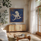 Treasures from the Sea Indigo V by Danhui Nai. Shown in a natural wood frame in a cozy modern living room. Available as an archival giclee rolled canvas, fine art paper, or poster print. SKU 20052a.