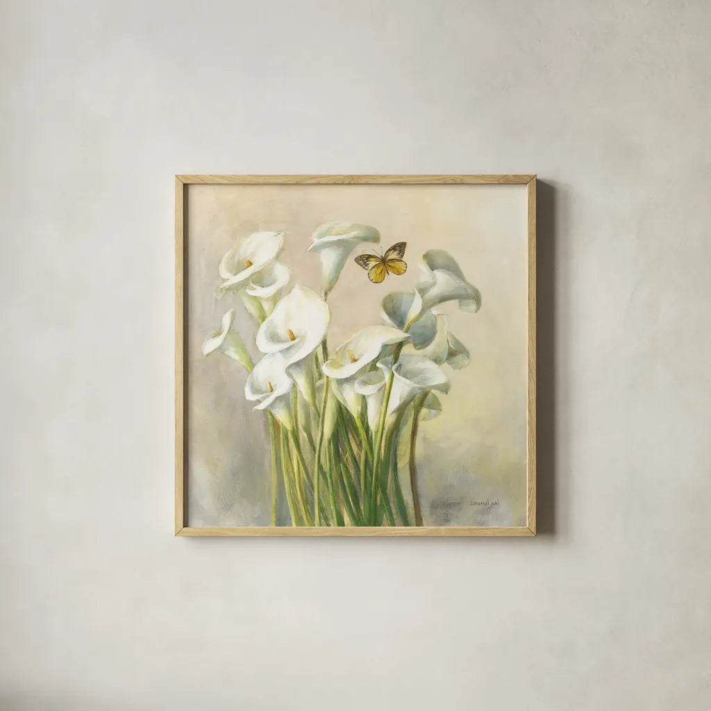 White Calla Lilies by Danhui Nai. Shown in a natural wood glass frame for a timeless modern aesthetic. Available as an archival giclee rolled canvas, fine art paper, or poster print. SKU 93198a.