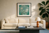 White Cherry Blossoms I on Blue Aged No Bird - 12x12 by Danhui Nai. Displayed in a glass frame with matte in a clean modern living room. Available as an archival giclee rolled canvas, fine art paper, or poster print. SKU 13840a.