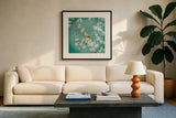 White Cherry Blossoms II on Blue Aged by Danhui Nai. Displayed in a glass frame with matte in a clean modern living room. Available as an archival giclee rolled canvas, fine art paper, or poster print. SKU 58677a.