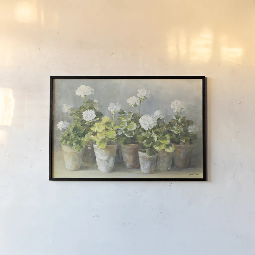 White Geraniums by Danhui Nai. shown as a paper print in a black flame. Available as a archival giclee rolled canvas, fine art paper, or poster print. SKU 13244i.