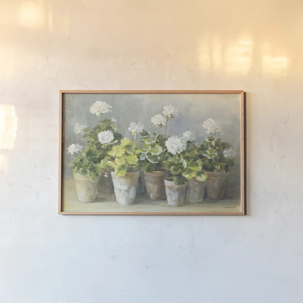 White Geraniums by Danhui Nai. shown as a paper print in a natural frame. Available as a archival giclee rolled canvas, fine art paper, or poster print. SKU 13244i.