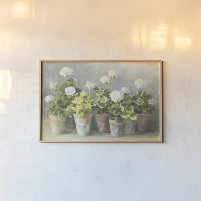 White Geraniums by Danhui Nai. shown as a paper print in a natural frame. Available as a archival giclee rolled canvas, fine art paper, or poster print. SKU 13244i.