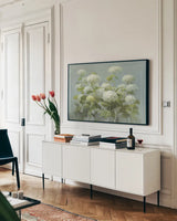 White Hydrangea Garden by Danhui Nai. shown as a framed stretched canvas in a living room above a console. Available as a archival giclee rolled canvas, fine art paper, or poster print. SKU 9375i.