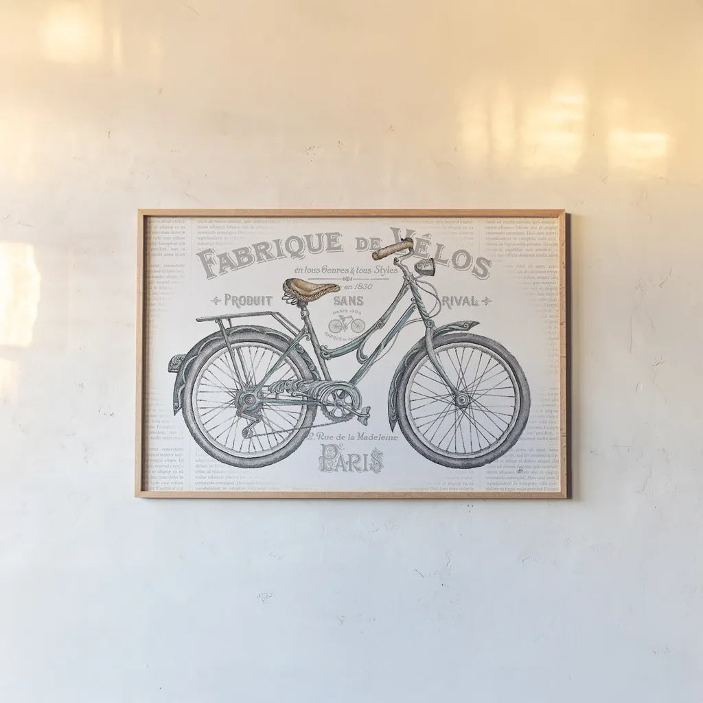 Bicycles I by Daphne Brissonnet. shown as a paper print in a natural frame. Available as a archival giclee rolled canvas, fine art paper, or poster print. SKU 28773i.
