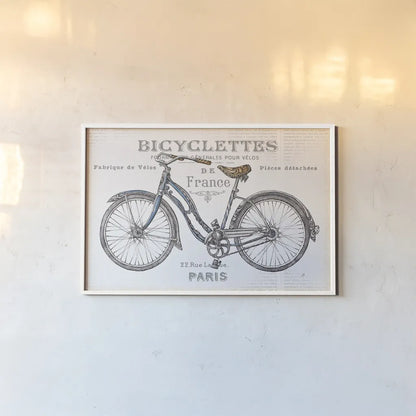 Bicycles II by Daphne Brissonnet. shown as a paper print in a white frame. Available as a archival giclee rolled canvas, fine art paper, or poster print. SKU 28774i.