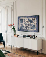 Desert Flair I by Daphne Brissonnet. shown as a framed stretched canvas in a living room above a console. Available as a archival giclee rolled canvas, fine art paper, or poster print. SKU 62044i.