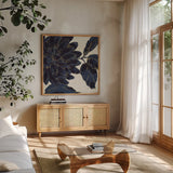 Indigo Garden I by Daphne Brissonnet. Shown in a natural wood frame in a cozy modern living room. Available as an archival giclee rolled canvas, fine art paper, or poster print. SKU 17327a.