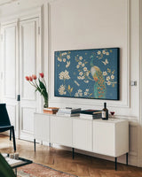 Ornate Peacock II Blue by Daphne Brissonnet. shown as a framed stretched canvas in a living room above a console. Available as a archival giclee rolled canvas, fine art paper, or poster print. SKU 53875i.