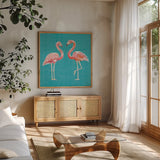 Tropical Oasis Pink Flamingos by Daphne Brissonnet. Shown in a natural wood frame in a cozy modern living room. Available as an archival giclee rolled canvas, fine art paper, or poster print. SKU 34976a.