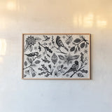 Woodcut Christmas II by Daphne Brissonnet. shown as a paper print in a natural frame. Available as a archival giclee rolled canvas, fine art paper, or poster print. SKU 69681i.
