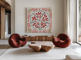 Woodcut Christmas X Color by Daphne Brissonnet. Shown as extra-large giant wall art in a modern living room. Available as an archival giclee rolled canvas, fine art paper, or poster print. SKU 69701a.