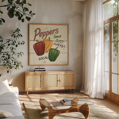 Sweet Peppers by David Carter Brown. Shown in a natural wood frame in a cozy modern living room. Available as an archival giclee rolled canvas, fine art paper, or poster print. SKU 3183a.