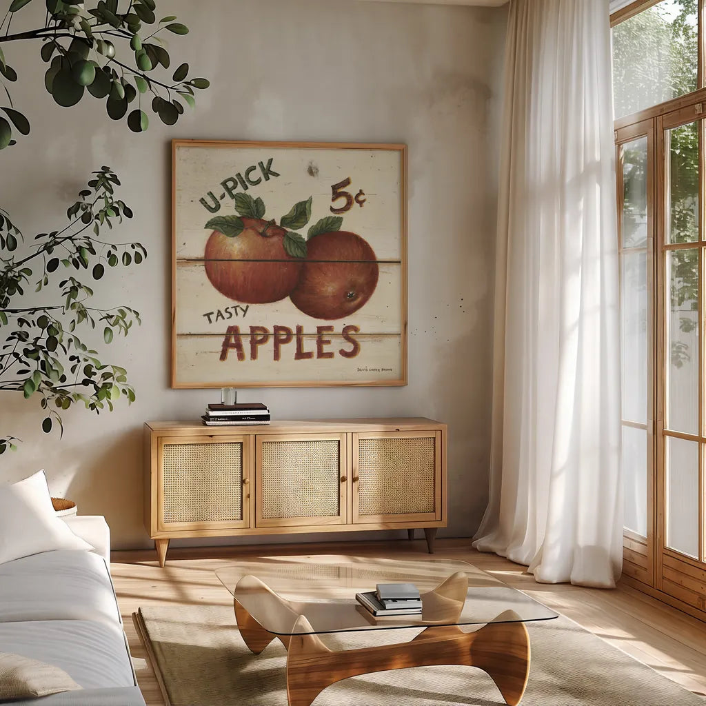 U-Pick Apples by David Carter Brown. Shown in a natural wood frame in a cozy modern living room. Available as an archival giclee rolled canvas, fine art paper, or poster print. SKU 3182a.