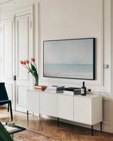 Aqua Sea by Deborah Revell. shown as a framed stretched canvas in a living room above a console. Available as a archival giclee rolled canvas, fine art paper, or poster print. SKU 91247i.