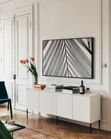 BW Fern I by Deborah Revell. shown as a framed stretched canvas in a living room above a console. Available as a archival giclee rolled canvas, fine art paper, or poster print. SKU 92032i.