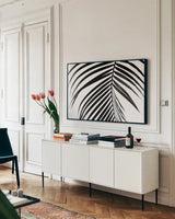 BW Fern V by Deborah Revell. shown as a framed stretched canvas in a living room above a console. Available as a archival giclee rolled canvas, fine art paper, or poster print. SKU 92036i.