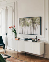 Beach Palms by Deborah Revell. shown as a framed stretched canvas in a living room above a console. Available as a archival giclee rolled canvas, fine art paper, or poster print. SKU 104902i.