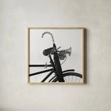Bike Detail IV by Deborah Revell. Shown in a natural wood glass frame for a timeless modern aesthetic. Available as an archival giclee rolled canvas, fine art paper, or poster print. SKU 104372a.