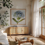 Blue Hydrangea by Deborah Revell. Shown in a natural wood frame in a cozy modern living room. Available as an archival giclee rolled canvas, fine art paper, or poster print. SKU 91227a.