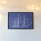 Blue Schooner II by Deborah Revell. shown as a paper print in a black flame. Available as a archival giclee rolled canvas, fine art paper, or poster print. SKU 104264i.