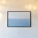 Blue Sea by Deborah Revell. shown as a paper print in a black flame. Available as a archival giclee rolled canvas, fine art paper, or poster print. SKU 103791i.