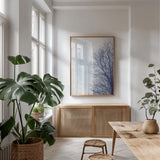 Blue Tree by Deborah Revell. shown as a print in a natural wood frame in a dining room. Available as a archival giclee rolled canvas, fine art paper, or poster print. SKU 90973h.