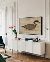 Canada Goose by Deborah Revell. shown as a framed stretched canvas in a living room above a console. Available as a archival giclee rolled canvas, fine art paper, or poster print. SKU 101624i.