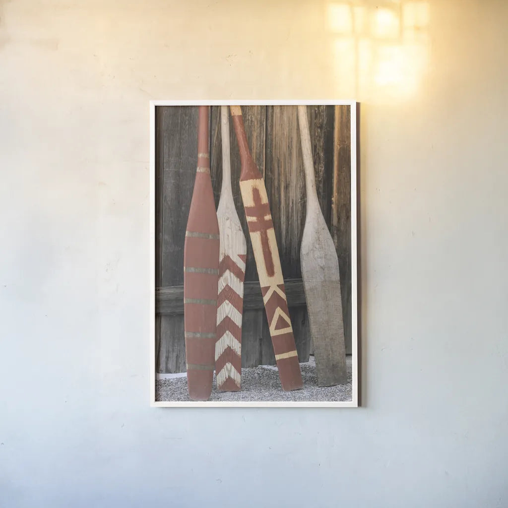 Canoe Paddles by Deborah Revell. shown as a paper print in a white frame. Available as a archival giclee rolled canvas, fine art paper, or poster print. SKU 96601h.