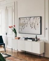 Catkins in Plaster I by Deborah Revell. shown as a framed stretched canvas in a living room above a console. Available as a archival giclee rolled canvas, fine art paper, or poster print. SKU 103706i.