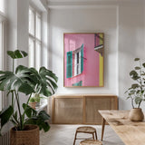 Cinque Terre Pink by Deborah Revell. shown as a print in a natural wood frame in a dining room. Available as a archival giclee rolled canvas, fine art paper, or poster print. SKU 95016h.