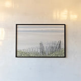 Coastal Fence I by Deborah Revell. shown as a paper print in a black flame. Available as a archival giclee rolled canvas, fine art paper, or poster print. SKU 102392i.