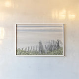 Coastal Fence I by Deborah Revell. shown as a paper print in a white frame. Available as a archival giclee rolled canvas, fine art paper, or poster print. SKU 102392i.