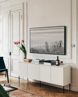 Coastal Fence I BW by Deborah Revell. shown as a framed stretched canvas in a living room above a console. Available as a archival giclee rolled canvas, fine art paper, or poster print. SKU 102395i.