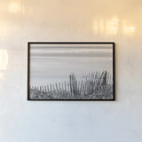 Coastal Fence I BW by Deborah Revell. shown as a paper print in a black flame. Available as a archival giclee rolled canvas, fine art paper, or poster print. SKU 102395i.