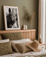Cottage Donkey II by Deborah Revell. shown as a paper print in a natural frame. Available as a archival giclee rolled canvas, fine art paper, or poster print. SKU 100060h.