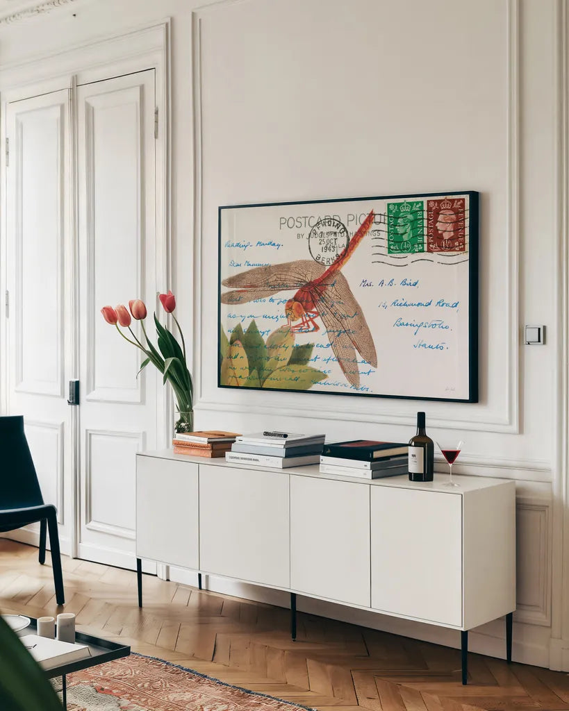 Dragonfly Postcard II by Deborah Revell. shown as a framed stretched canvas in a living room above a console. Available as a archival giclee rolled canvas, fine art paper, or poster print. SKU 91115i.