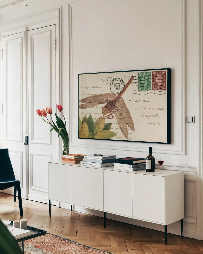 Dragonfly Postcard II Cream by Deborah Revell. shown as a framed stretched canvas in a living room above a console. Available as a archival giclee rolled canvas, fine art paper, or poster print. SKU 92751i.