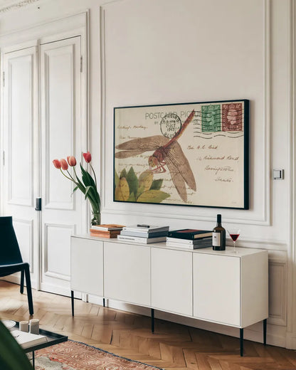 Dragonfly Postcard II Cream by Deborah Revell. shown as a framed stretched canvas in a living room above a console. Available as a archival giclee rolled canvas, fine art paper, or poster print. SKU 92751i.