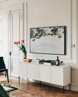 Eucalyptus by Deborah Revell. shown as a framed stretched canvas in a living room above a console. Available as a archival giclee rolled canvas, fine art paper, or poster print. SKU 93443i.