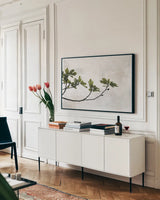 Fig Branch by Deborah Revell. shown as a framed stretched canvas in a living room above a console. Available as a archival giclee rolled canvas, fine art paper, or poster print. SKU 94137i.