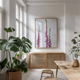 Foxgloves by Deborah Revell. shown as a print in a natural wood frame in a dining room. Available as a archival giclee rolled canvas, fine art paper, or poster print. SKU 93428h.